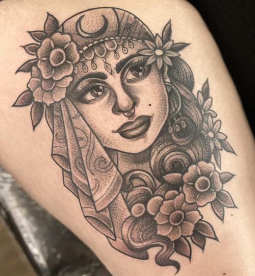 black and grey stippled gypsy head traditional thigh tattoo