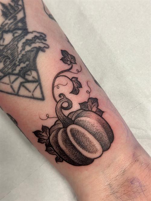 pumpkin gapfiller black and grey dotwork pepper shading wrist tattoo